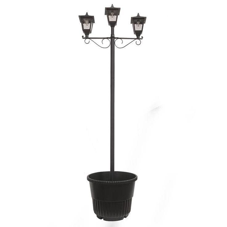 a potted plant with three lights on it and a light pole in the background