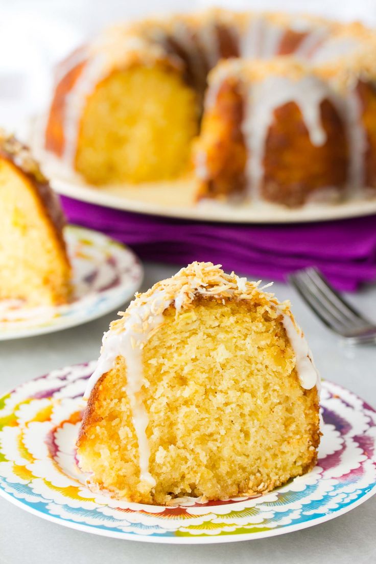 a bundt cake with white icing on a plate next to another bundt cake