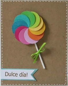 a colorful lollipop on top of a brown card