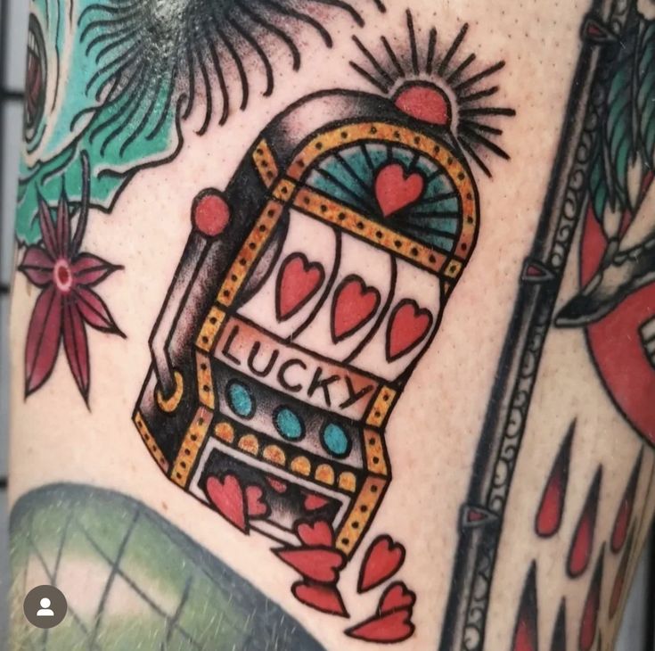 a close up of a person's leg with tattoos on it and an image of a lucky machine