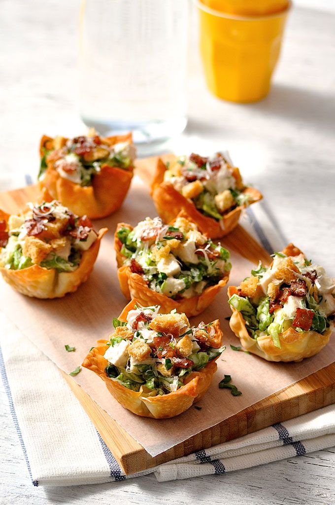 small appetizers are sitting on a cutting board