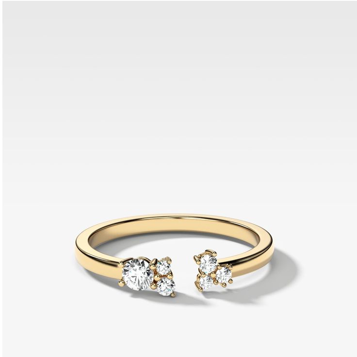 a gold ring with two diamonds on it