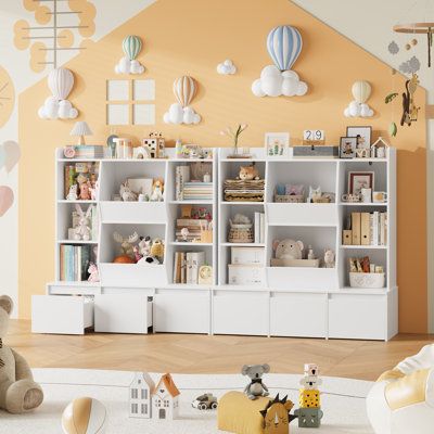 a child's room with toys, bookshelves and stuffed animals