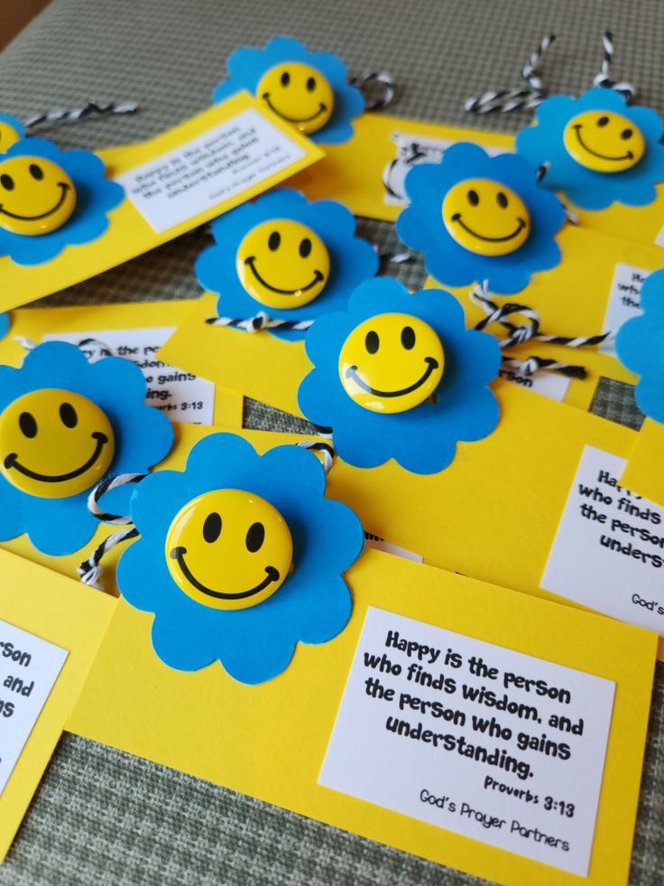 some yellow and blue cards with smiley faces on them