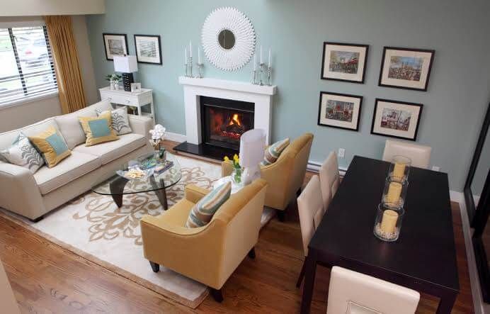 a living room filled with furniture and a fire place in the middle of a room