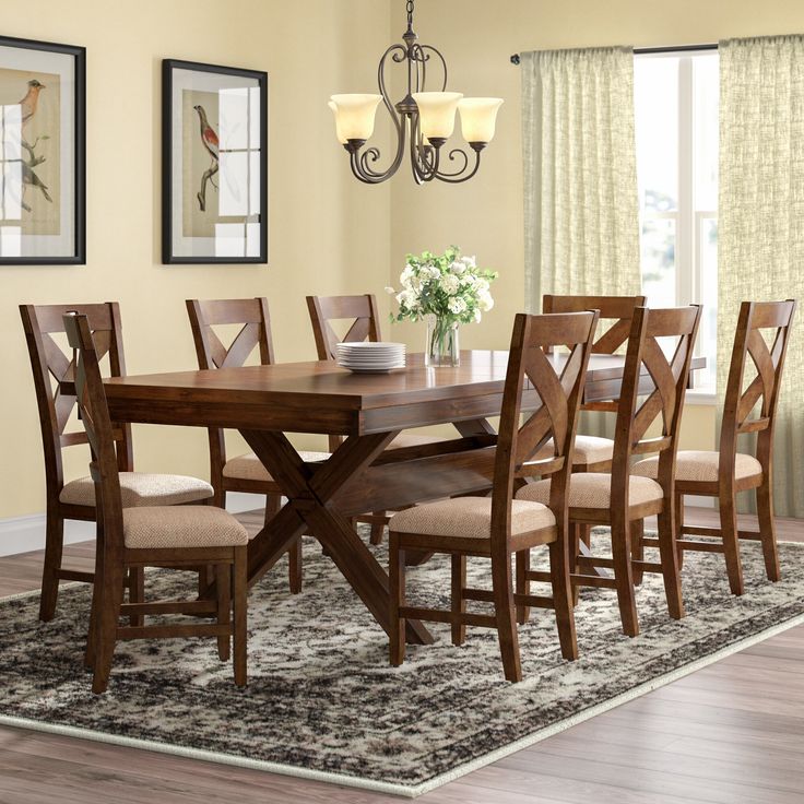 a dining room table with chairs and a chandelier