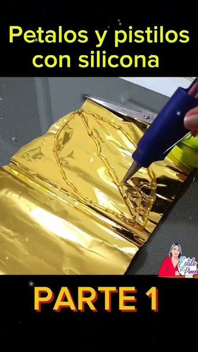 a person is painting gold foil on a piece of metal