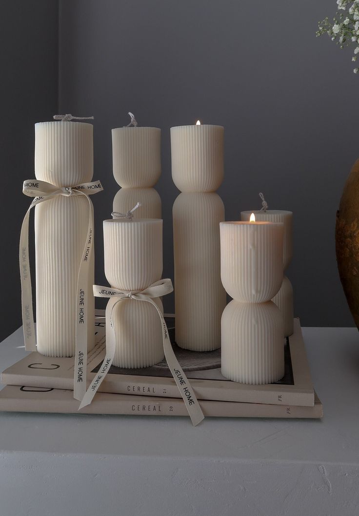 a group of white candles sitting on top of a table