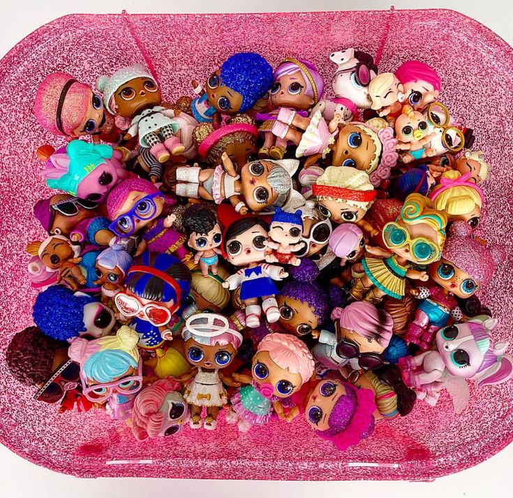 a pink container filled with lots of little dolls