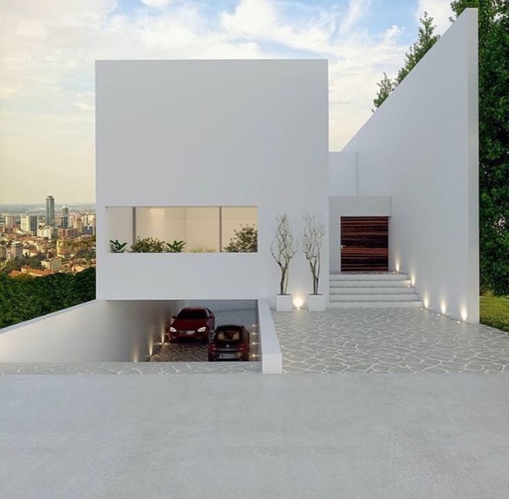 a white house with stairs leading up to the top floor and trees in front of it