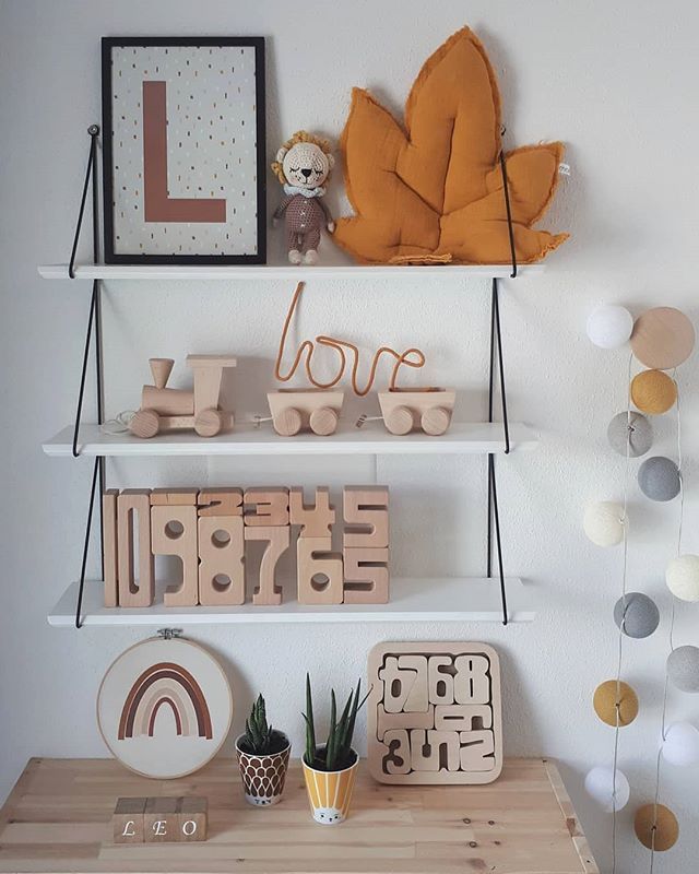 the shelves are decorated with wooden letters and decorations