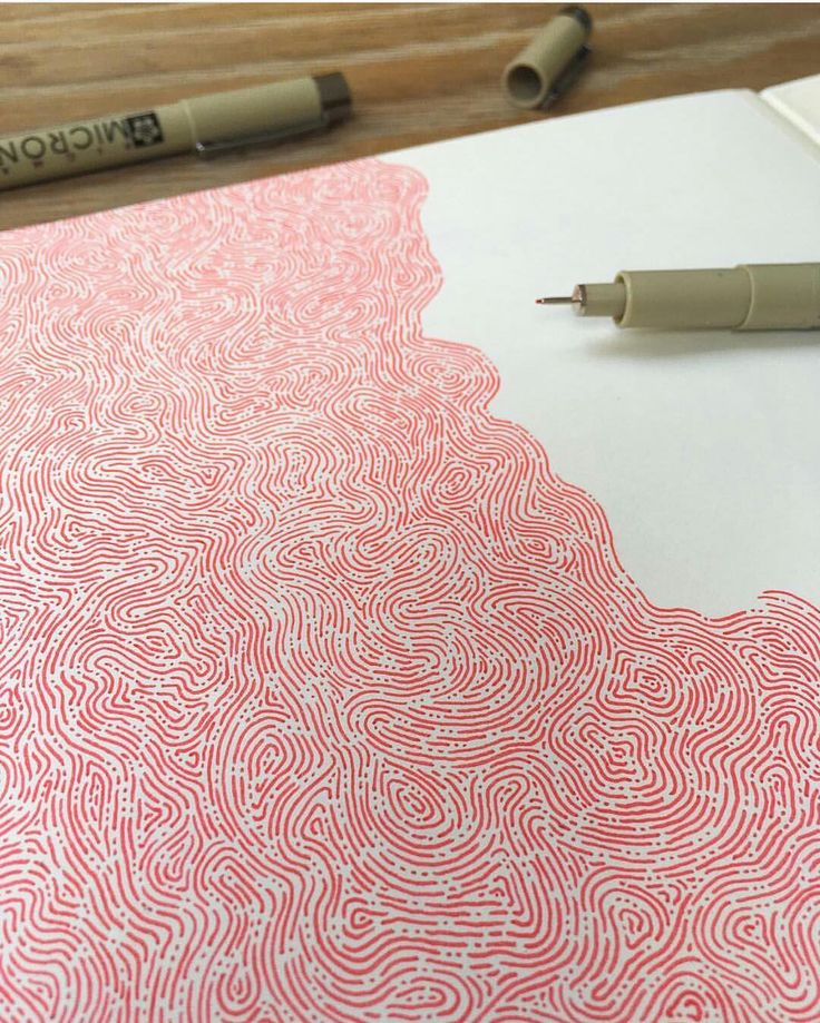 a pen is sitting on top of a drawing paper