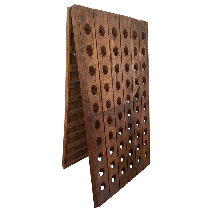 a wooden rack with holes in it on a white background and the bottom section is made out of wood