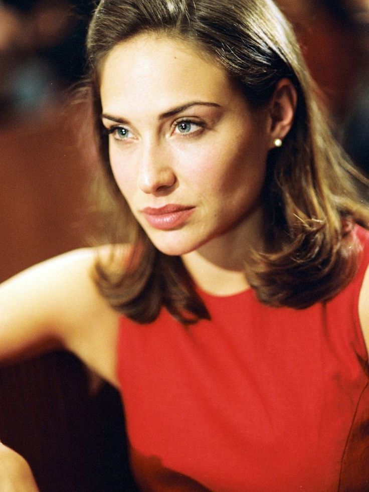 a woman in a red dress is posing for a photo with her hand on her hip