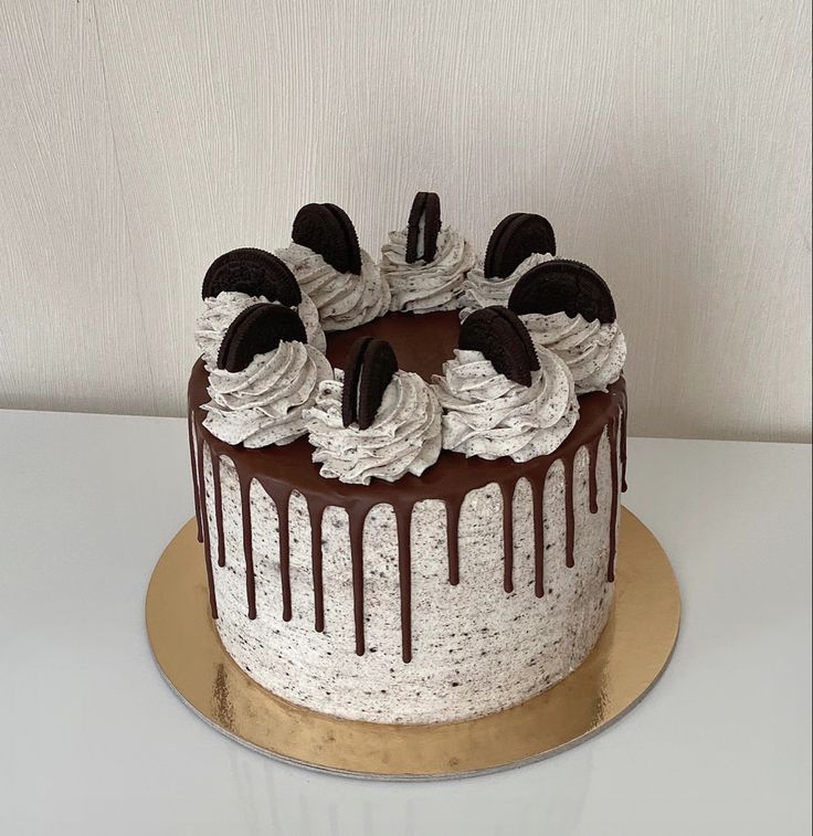 a chocolate cake with white frosting and oreo cookies