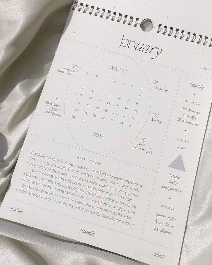 a calendar is laying on top of a sheet of white fabric with the word january written in it