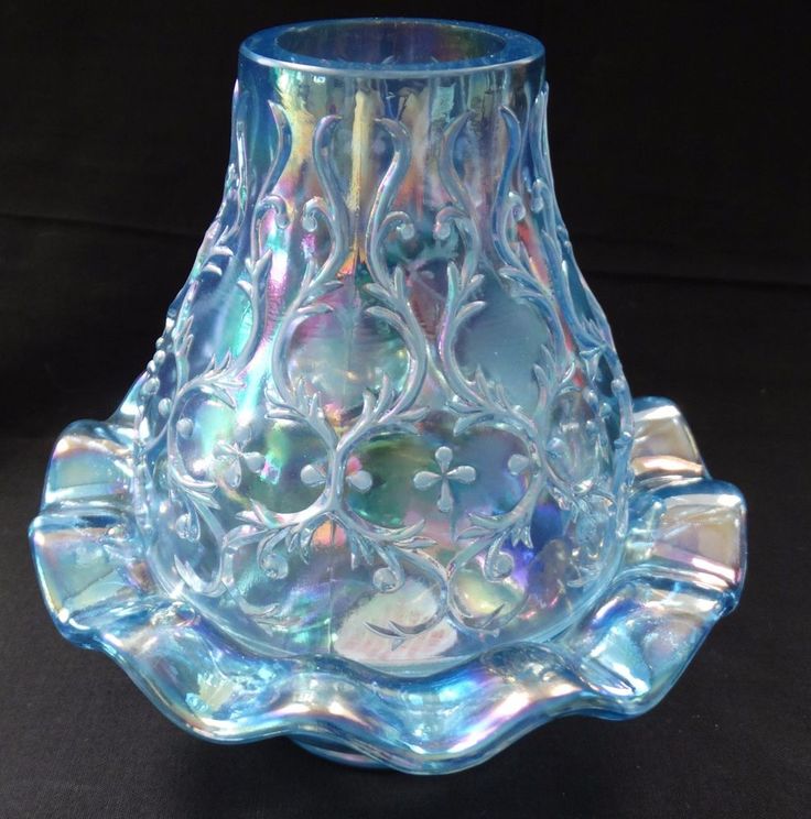 a blue glass vase sitting on top of a table