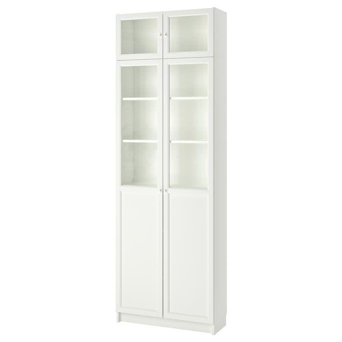 a white bookcase with glass doors on the front and bottom shelves, against a white background