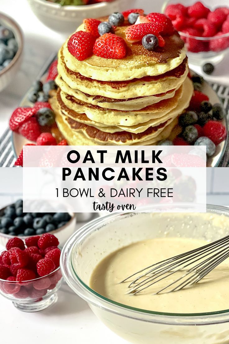 a stack of pancakes with berries and blueberries on top next to a bowl of pudding