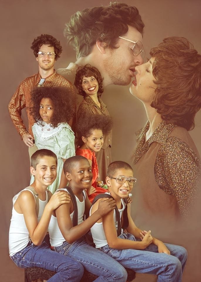 a group of people are posing together for a photo with the man kissing the woman's face