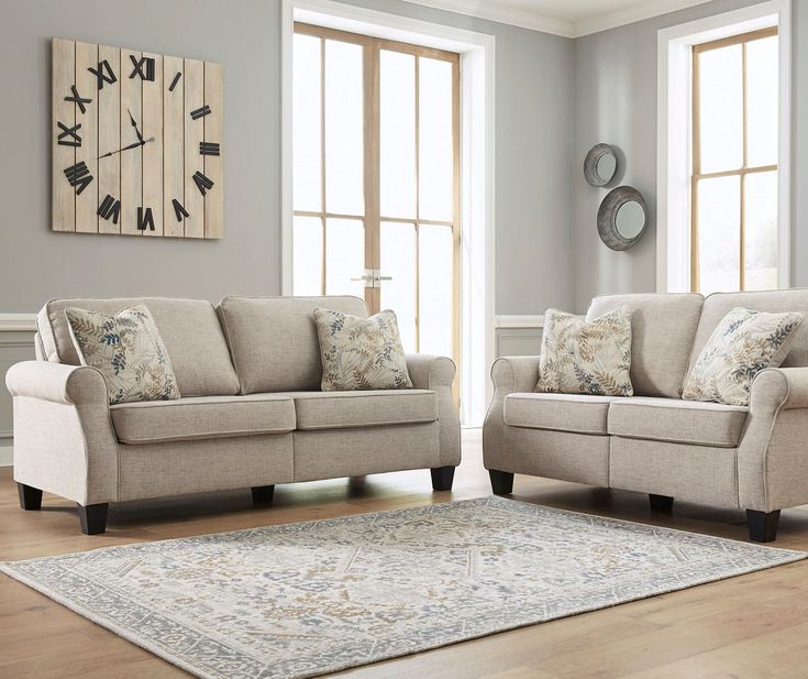 a living room with two couches and a rug