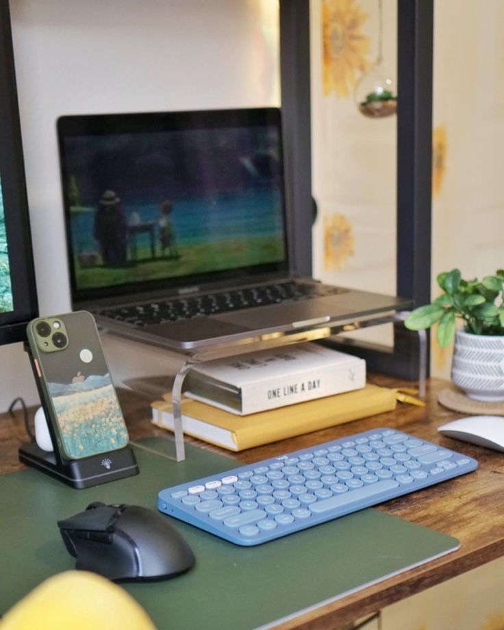 a laptop computer sitting on top of a wooden desk next to a keyboard and mouse