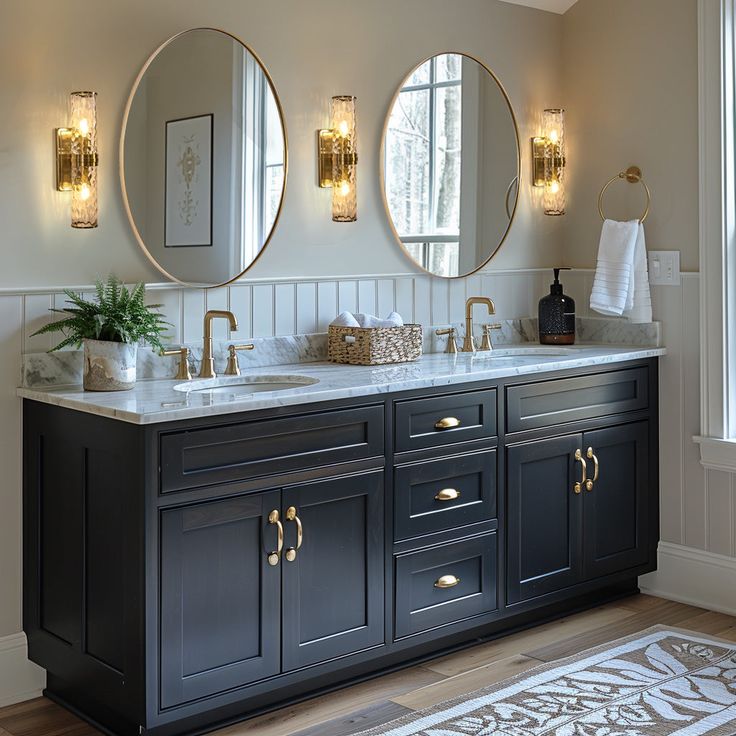 a bathroom with double sinks and mirrors on the wall