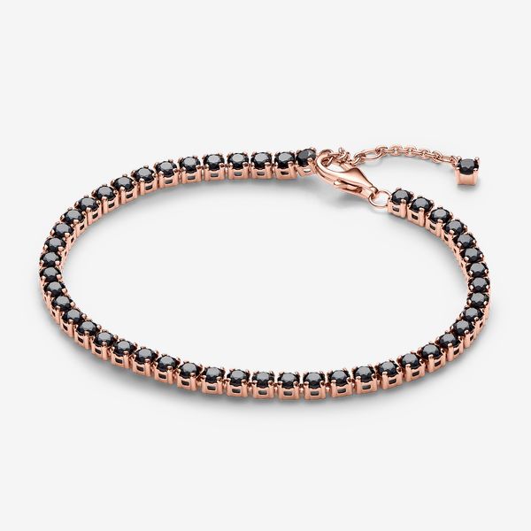 Add boldness to your look with the Black Sparkling Tennis Bracelet. Plated with 14k rose gold, it showcases 48 prong-set black man-made crystals in squared open baskets. The adjustable closure with a dangling stone offers a personalized fit. Ideal for stacking with various colours and metals, this bracelet introduces a bold black stone to Pandora's Timeless collection. Experience the elegance of repetition and contrast, adding depth to your bracelet stack. - Pandora Black Sparkling Tennis Bracelet - 14k Rose gold-plated unique metal blend / Man-made crystal / Black - Sz. 7.9 in Elegant Rose Gold Jewelry With Black Diamonds, Rose Gold Jewelry With Black Diamonds, Formal Rose Gold Jewelry With Black Diamonds, Pandora Black, Black Man, Bold Black, Black Stone, Lab Created Diamonds, Tennis Bracelet