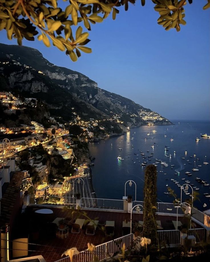 an aerial view of boats in the water at night