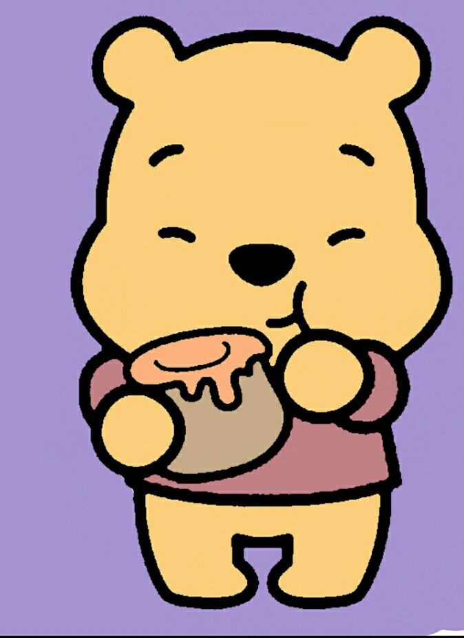 a winnie the pooh bear holding a cupcake