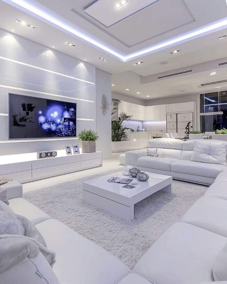 a large living room with white furniture and lighting