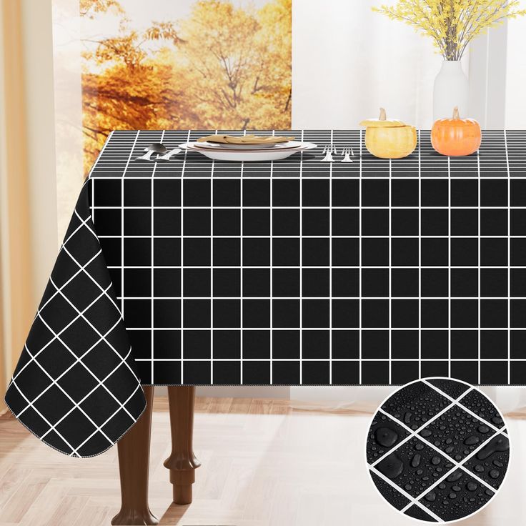 a black table cloth with white squares and pumpkins in the background on a wooden floor