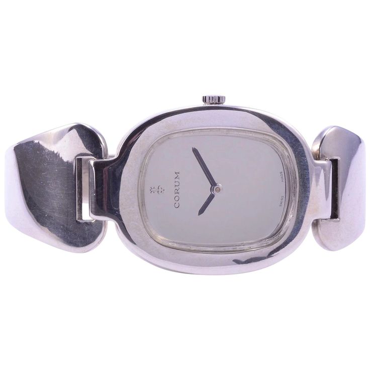 Vintage Swiss rare Corum sterling silver cuff wrist watch, circa 1970. This Corum sterling cuff wrist watch features a polished silver dial and 17 jewel movement #106825. Case #57300. This is a rare limited production wrist watch. [SSHO 888] Dimensions: 28mm H x 42mm W x 7mm D (case); 6″L x .80″W x .10″D Warranty: This watch comes with a full one year warranty from the date of purchase. Watch Silver Women, Solvang Ca, Silver Gift Wrap, Bangle Watches, Hand Watch, Eternity Band Diamond, Silver Gifts, Sterling Silver Cuff, Hinged Bangle