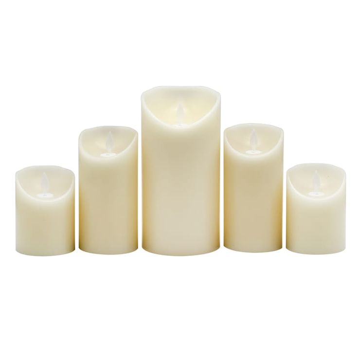 five white candles are lined up in a row