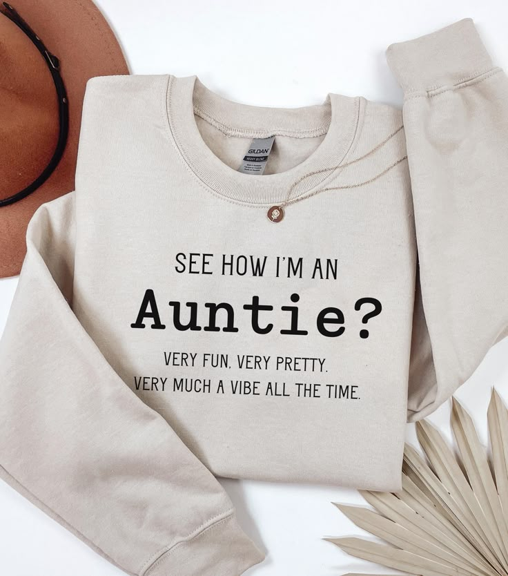 Welcome to our cozy corner of Etsy, where style meets sass with a touch of sweetness! Our Demure but Funny Auntie Sweatshirt is the perfect blend of elegance and humor--just like your favorite auntie. Crafted for those who cherish subtle sophistication with a wink of wit, this sweatshirt is a must-have for any aunt who knows how to keep it classy while sharing a laugh. .: Made with a medium-heavy fabric blend of 50% cotton and 50% polyester (8.0 oz/yd² (271.25 g/m this sweatshirt feels cozy and is the perfect choice for those colder months. .: The classic fit along with the crew neckline deliver a comfy wearing experience with a clean-cut style. Meanwhile, the double-needle stitching at the shoulder, armhole, neck, waistband, and cuff seams add top-tier durability.  .: Say goodbye to itchi Aunt Gifts From Kids, Auntie Sweatshirt Ideas, Bestie To Auntie, Auntie Aesthetic, Auntie Sweatshirt, Auntie Life, Aunt Quotes, Auntie Shirts, Aunt Life