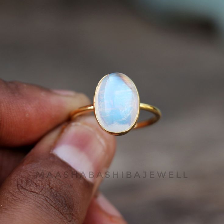 Natural Moonstone Ring, Solitaire Engagement Ring, 18k Gold Vermeil Ring, Birthstone Ring, Rainbow Moonstone Ring, Dainty Weeding Women Ring SHOP LINK:- https://www.etsy.com/shop/MaaShabashibaJewell?ref=seller-platform-mcnav 》D E T A I L S《 Gemstone: Natural Rainbow Moonstone Gem Color: Blue Stone Shape: Oval Metal: 925 Sterling Silver Purity: 925 Parts Per 1000 Setting Type: Bezel Set Silver Polish: High Ring Size: All Size Available Please note that there Can be slight variations in stone text Luxury Gift Moonstone Open Ring, Celestial Wedding Ring With Bezel Setting, Delicate White Moonstone Gemstone Ring, Delicate White Gemstone Rings, Delicate White Moonstone Ring, Elegant Handmade Stackable Moonstone Rings, Elegant Handmade Moonstone Stackable Rings, Yellow Gold Moonstone Cabochon Ring For Wedding, Handmade Elegant Moonstone Stackable Rings