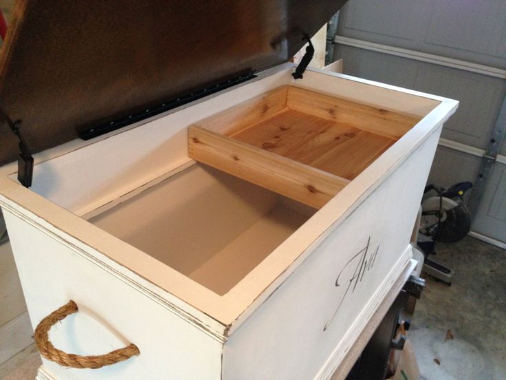 an old fashioned chest is being worked on with some wood and rope attached to it