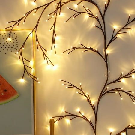 a watermelon slice on a table with lights around it and a tree branch