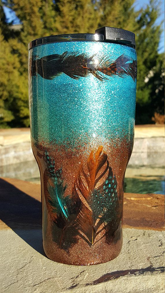 a close up of a cup on the ground with trees in the backgroud