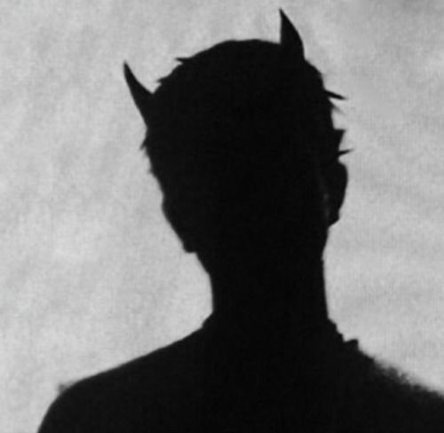 the silhouette of a man with horns on his head