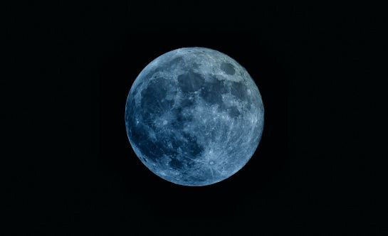 the full moon is seen in the dark sky