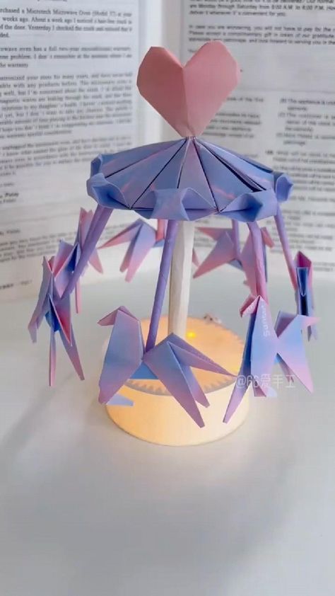 an origami carousel with hearts on top