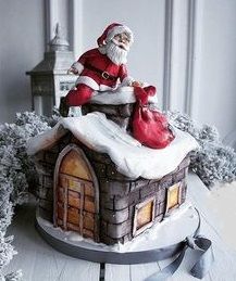 a santa clause sitting on top of a small house