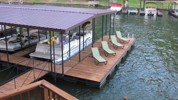 a boat dock with lounge chairs on it