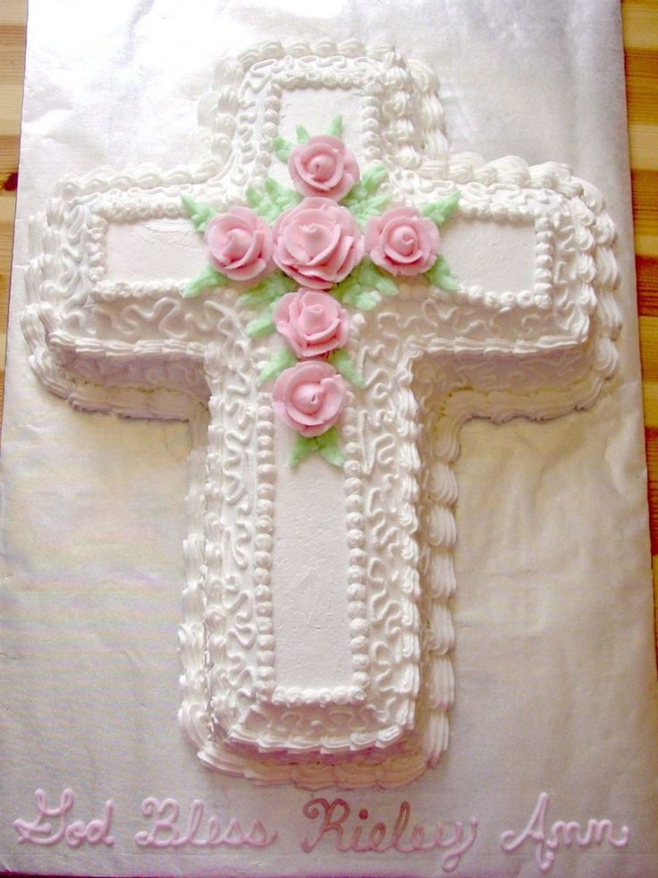 a cake decorated with pink roses on top of a table