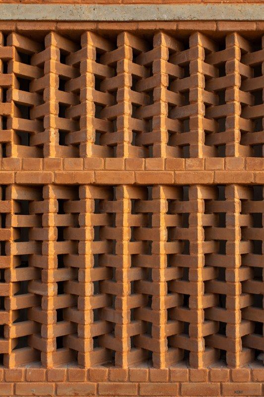 a close up view of a brick wall with vertical bars on the top and bottom