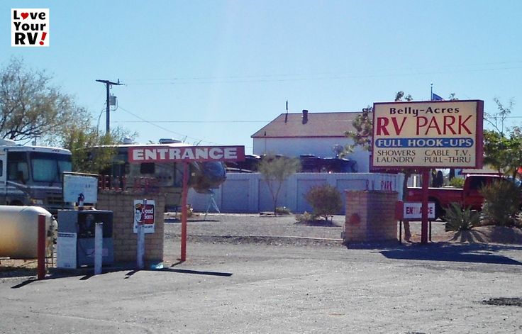 an rv park with two trucks parked in front of it