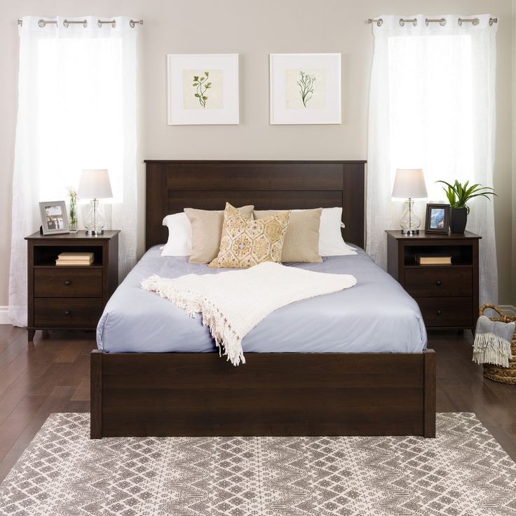 a large bed sitting in a bedroom next to two nightstands on either side of the bed