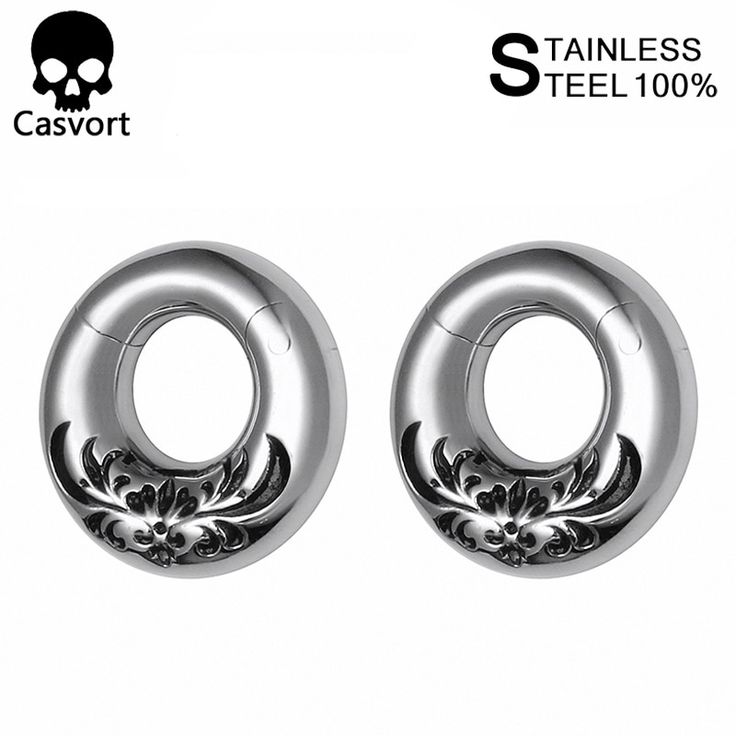 pair of silver earrings with floral design on the front and back, in an oval shape