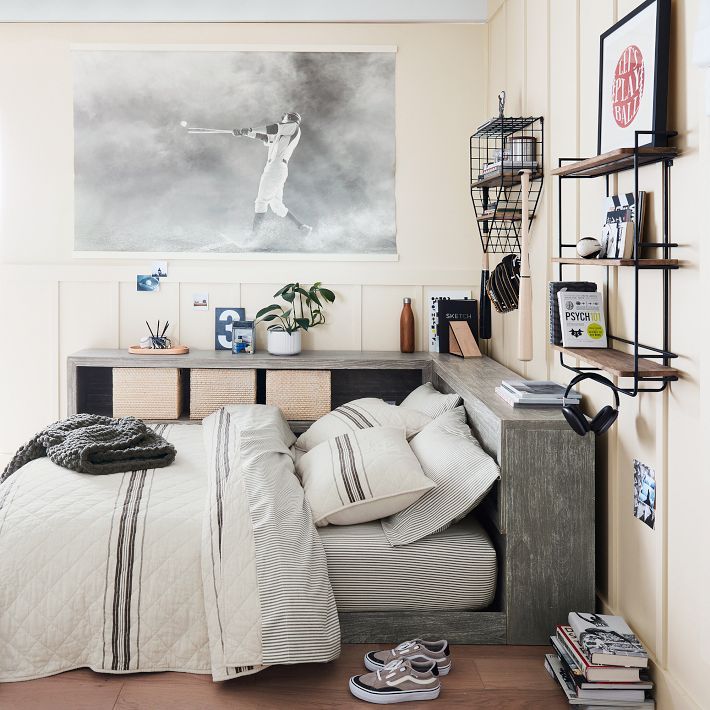 a bed room with a neatly made bed and a painting on the wall above it